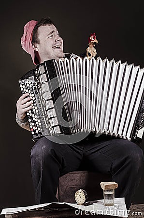 Russian poor man with an accordion and vodka Stock Photo