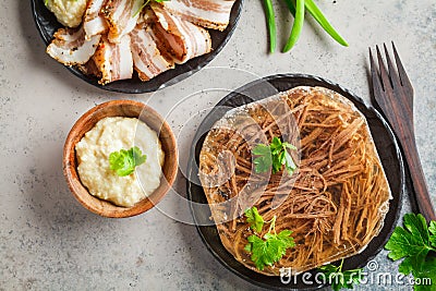 Russian pork and beef jellied meat with horseradish and parsley, top view. Traditional Russian cuisine concept Stock Photo