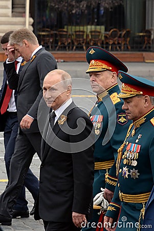 Russian President Vladimir Putin with defense Minister Sergei Shoigu and army General Oleg Salyukov during the celebration of the Editorial Stock Photo