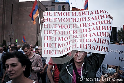 Russian protester with a poster against mobilization at a demonstration in Yerevan Editorial Stock Photo