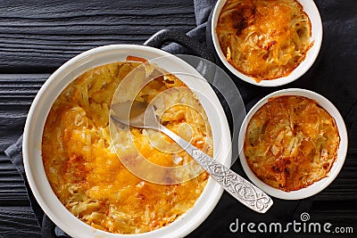 Russian Romanoff casserole made from potatoes, sour cream and cheddar cheese close-up in a pan. horizontal top view Stock Photo