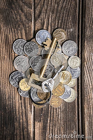 Bunch of coins on the aged rough wooden windowsill. Stock Photo