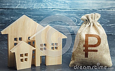 Russian ruble money bag and figurines of residential buildings. Property tax. Increase investment attractiveness Stock Photo