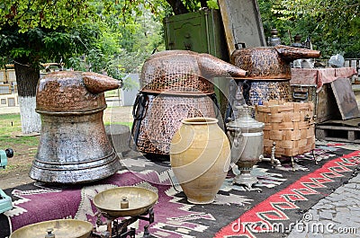 Russian samovar and old copper tanks for making grape vodka Stock Photo