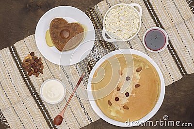 Russian Shrovetide Maslenitsa Butter Week festival meal homemade. Blini crepes pancakes with fresh cottage cheese, sour cream Stock Photo