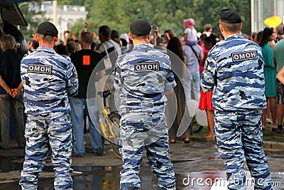 Russian soldiers of Special Purpose Mobile Unit OMON, or Black Berets monitoring compliance with the order at a crowded event Editorial Stock Photo