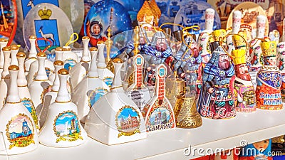 Russian souvenirs bells are sold with samaras on the market. Text in Russian: Samara, bell Editorial Stock Photo