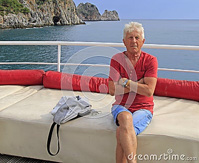 Russian tourist against the background of sea and rocks Stock Photo