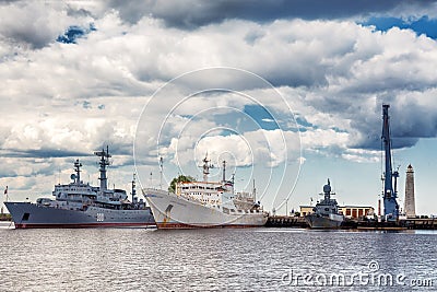 Russian warships and the oceanographic research vessel Admiral Vladimirsky are in Srednyaya gavan Middle harbor in Kronstadt Editorial Stock Photo