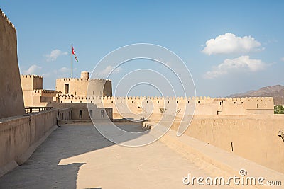 Rustaq castle with an Omani flag on a sunny day. Editorial Stock Photo