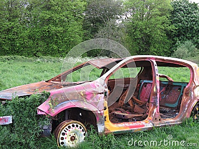 Rusted Abandoned Car In Field Stock Photo