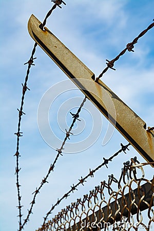 Rusted barbed wire fence Stock Photo