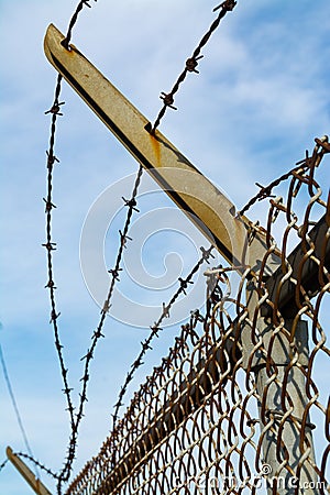 Rusted barbed wire fence Stock Photo