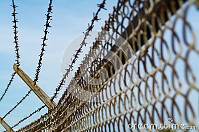 Rusted barbed wire fence Stock Photo