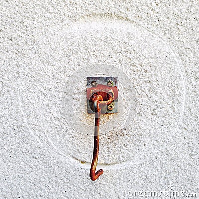 Rusted door hook with round trace on white wall Stock Photo