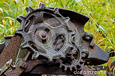 Rusted Gears Of A Long Abandoned Piece Of Farm Equipment Stock Photo