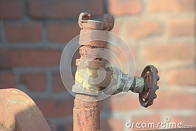 Rusted iron pipe with shut-off valve in an old factory Stock Photo