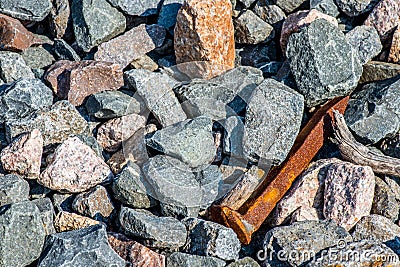 Rusted Railroad Spike in Loose Rock Stock Photo