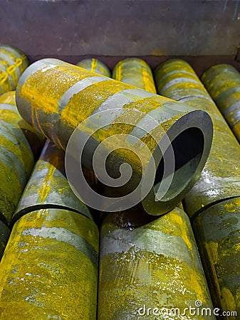 rusted thick steel pipe chunks after sawing waiting for machining operations Stock Photo