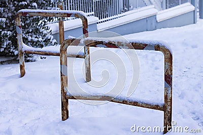 Rusted traffic bollards on a snowy street Stock Photo