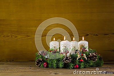 Rustic advent wreath or crown with four burning white candles. Stock Photo