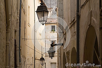 Rustic Alley with Old Limestone Houses and Lanterns, Montpelier, France Stock Photo
