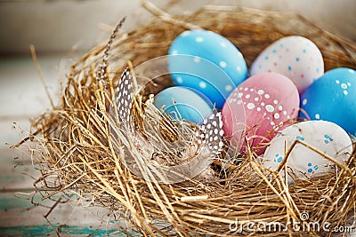 Rustic Blue, Red and White Egg in the Hay Nest Stock Photo