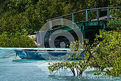 Rustic boat in a quiet lagoon. Stock Photo