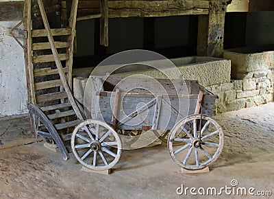 Rustic cart. Vintage wooden wagon in the stable. Stock Photo