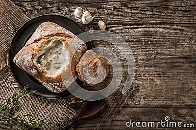 Rustic chicken soup with mushrooms in bread with spices on rustic wooden background. Healthy food concept, top view, flat lay, Stock Photo