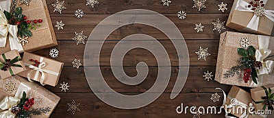 Rustic Christmas banner with border of gift boxes on dark brown wood background Stock Photo