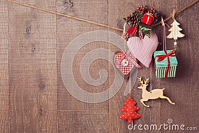 Rustic Christmas decorations hanging over wooden background with copy space Stock Photo