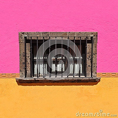 Rustic Colonial window with colorful wall Stock Photo