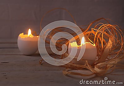 Rustic composition with candles and eggs. Happy easter. Selective focus. Stock Photo