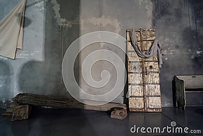 Rustic concrete designer interior with old wooden door, bench and column. Natural light with shadows on the wall. Inspiration Stock Photo