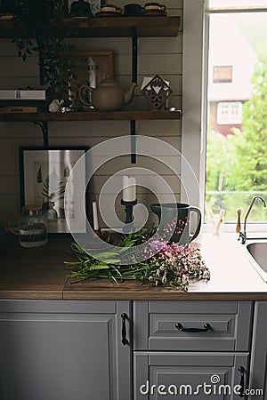 rustic dark wooden cottage kitchen in grey and brown colors Stock Photo