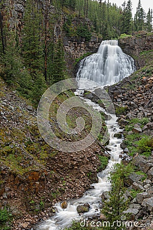 Rustic Falls Drains into River Stock Photo