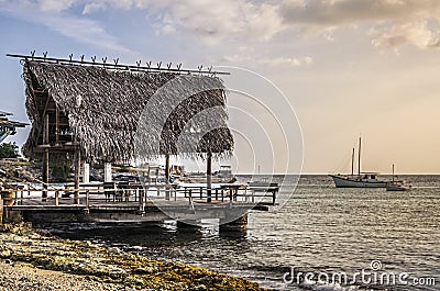 Rustic fishing pier in Curacao at sunset Stock Photo