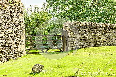 Rustic gate in drystone wall in Bibury England UK. Stock Photo