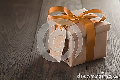 Rustic gift box with orange ribbon bow and empty tag Stock Photo