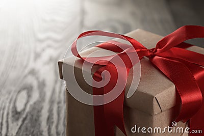 Rustic gift box with red ribbon bow Stock Photo