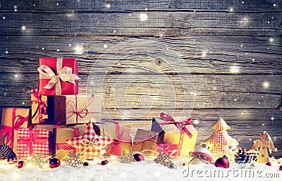 Rustic Gift Boxes On Snow With Christmas Ornament Stock Photo