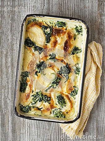 Rustic golden spinach potato gratin dauphinois Stock Photo