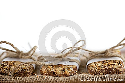 Rustic Granola Bars wrapped with Twine on Burlap White BG Stock Photo