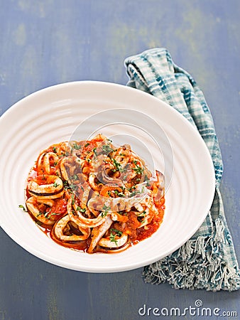 Rustic italian calamari in spicy tomato sauce Stock Photo