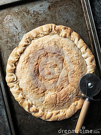 Rustic italian calzone stuffed pizza Stock Photo