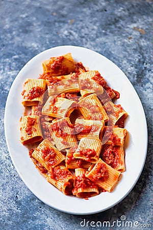 Rustic italian paccheri pasta in tomato sauce Stock Photo