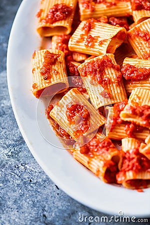 Rustic italian paccheri pasta in tomato sauce Stock Photo