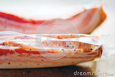 Rustic italian pancetta bacon in plastic packaging Stock Photo