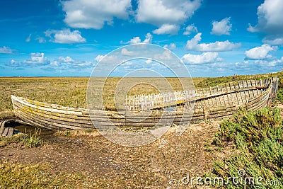 Rustic old boat left to decay on Salt Marshes between Blakeney and Cley Stock Photo